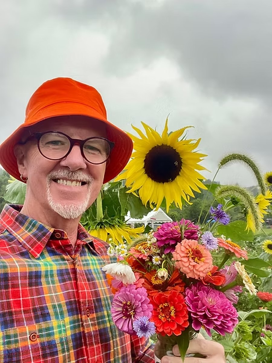 Michael Edsel outdoors among flowers